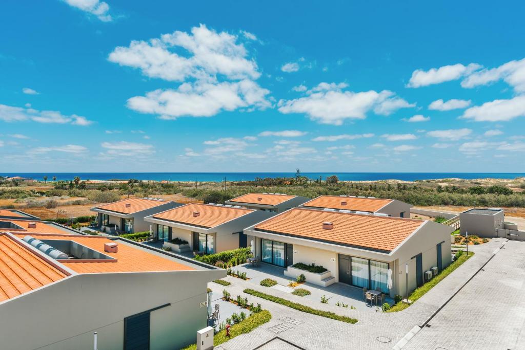 an aerial view of a house with the ocean in the background at Vila Baleira Village in Porto Santo