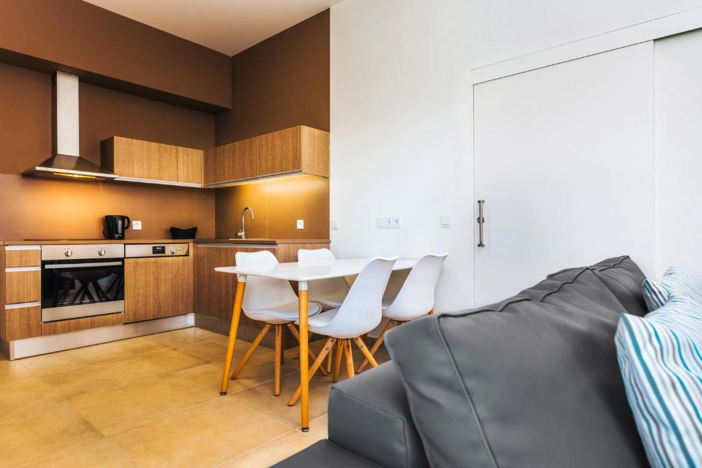 a kitchen with a table and chairs in a room at Vila Baleira Village in Porto Santo