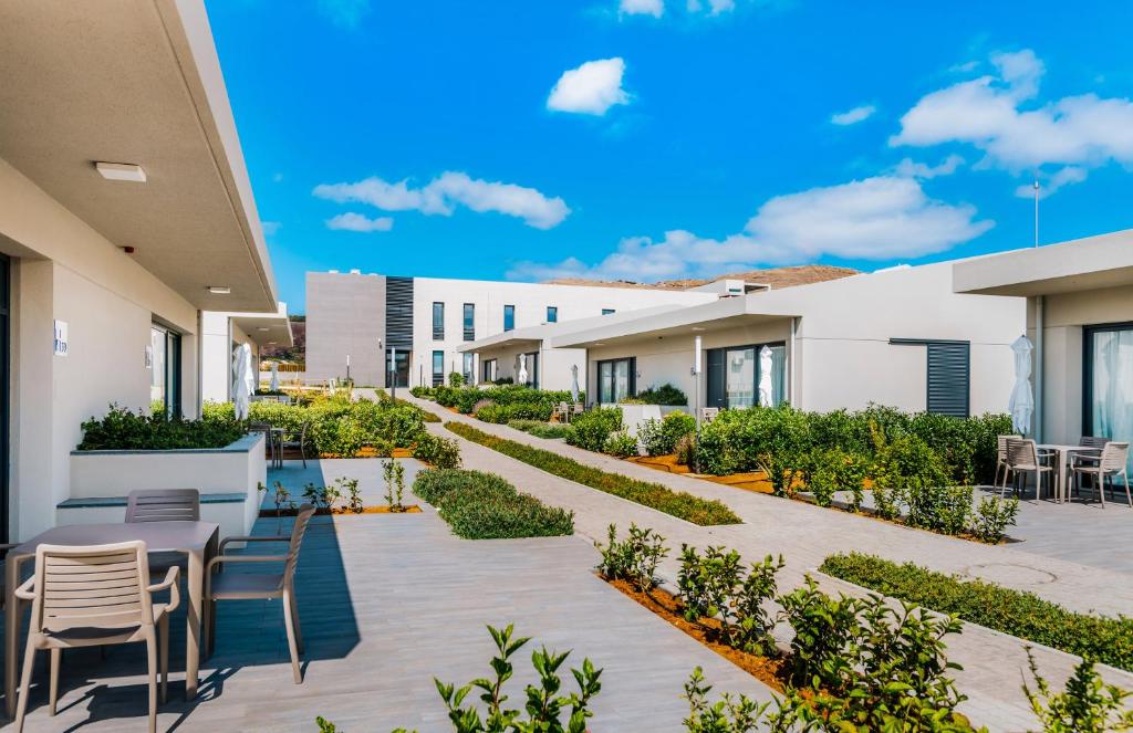 a courtyard with tables and chairs in a building at Vila Baleira Village in Porto Santo