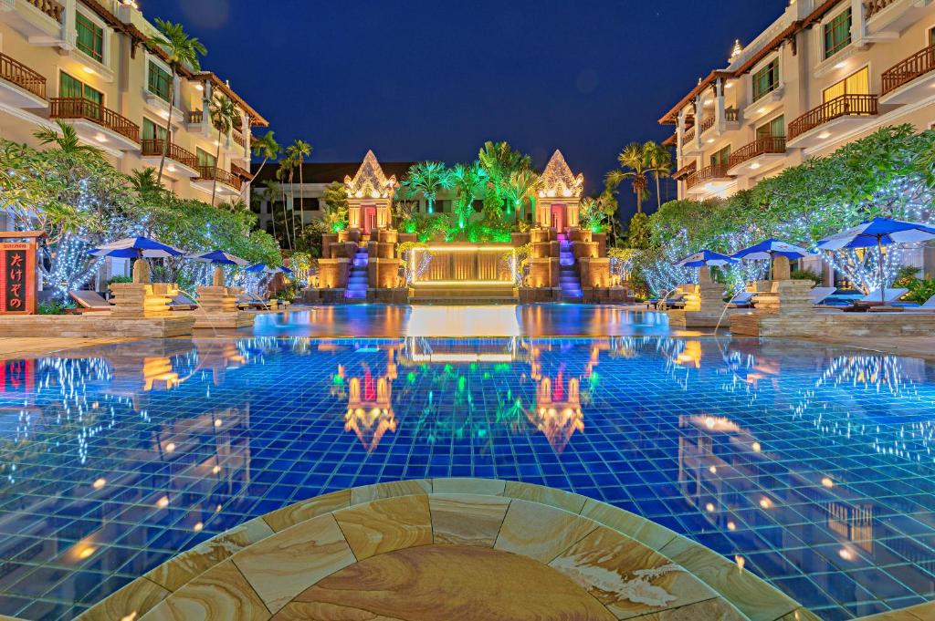 a pool at a resort at night at Sokha Angkor Resort in Siem Reap