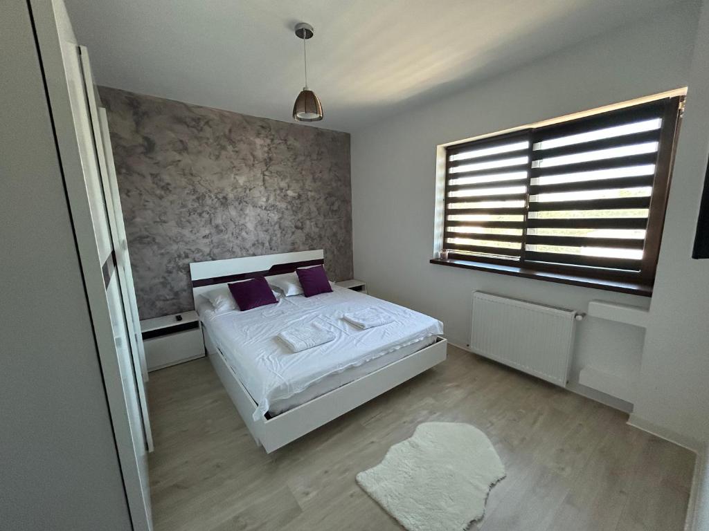 Ένα ή περισσότερα κρεβάτια σε δωμάτιο στο VD Apartament