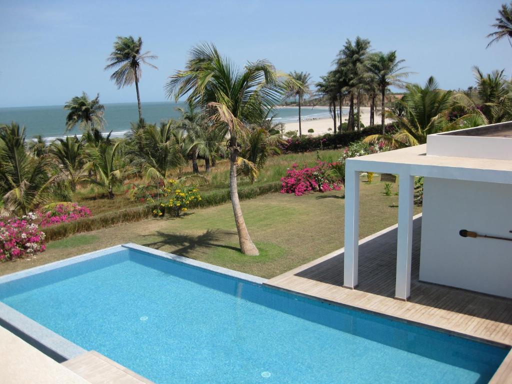 a swimming pool with a view of the beach at Amigo 2 in Cap Skirring