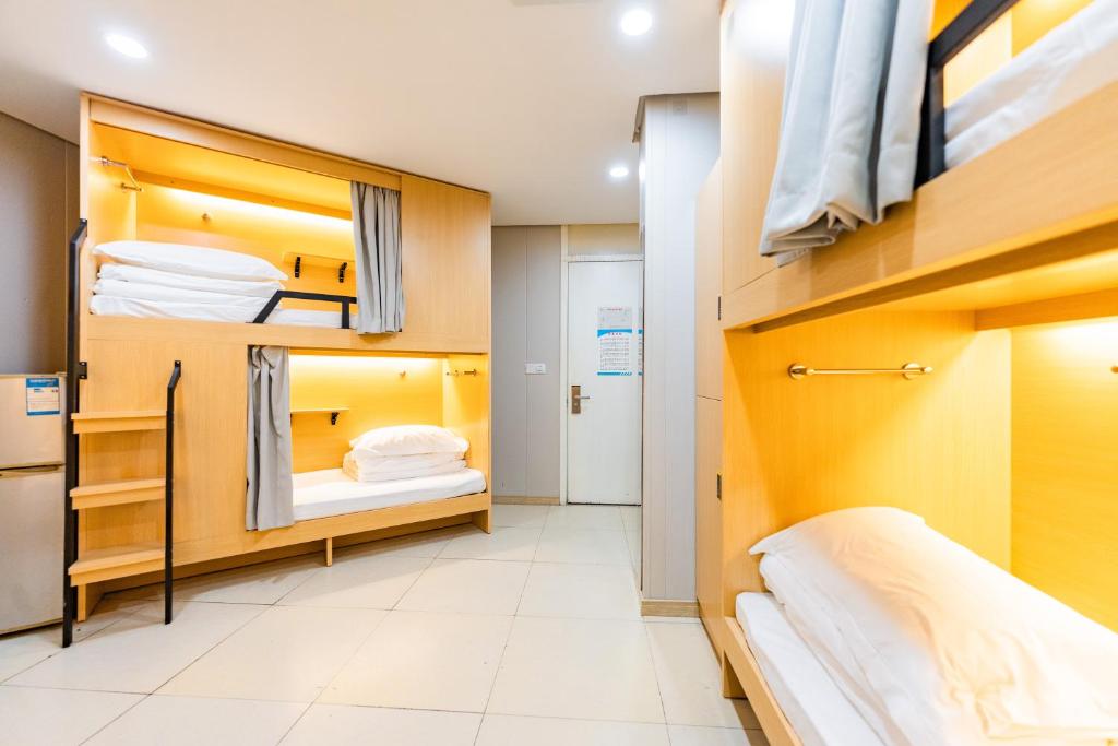 a small room with bunk beds in it at Shanghai Koala International Youth Hostel in Shanghai