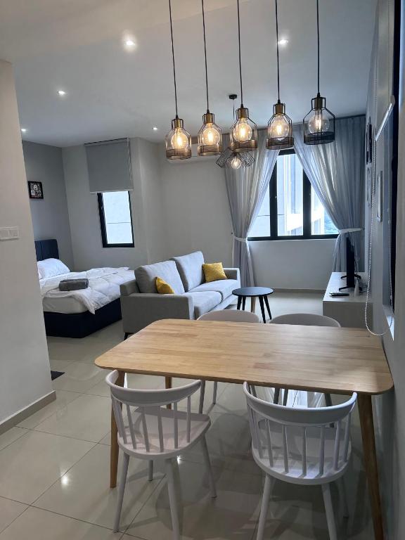 a living room with a table and a couch at Wanderlust Retreat Studio by Iconic Regency in Bayan Lepas