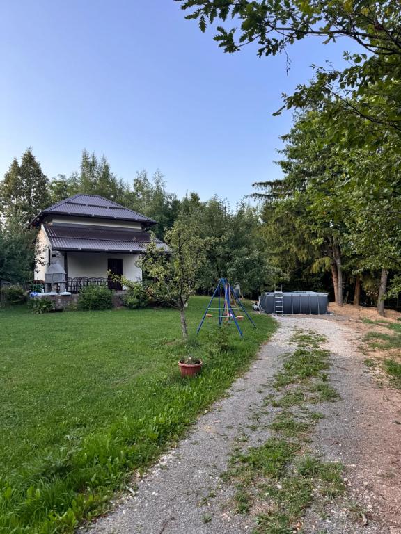 a yard with a playground and a house at Čarobna Kućica Pale in Pale