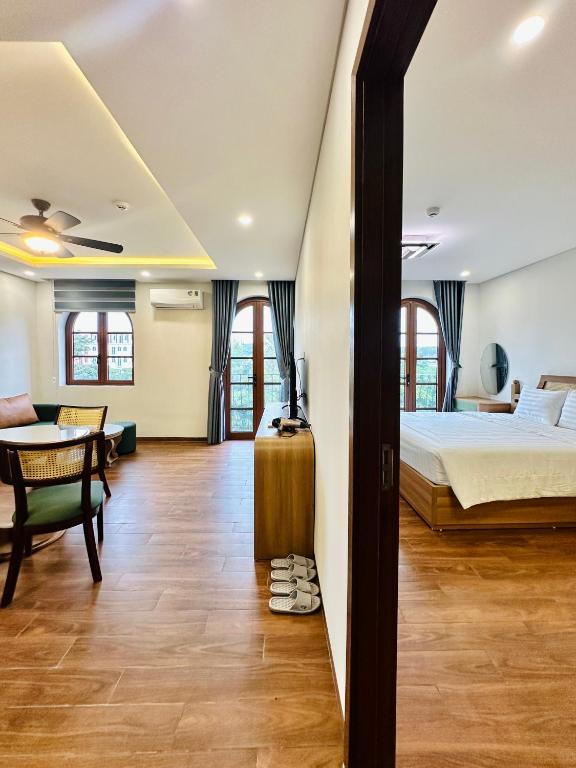 a hotel room with a bed and a desk at Momento Phu Quoc Hotel in Phu Quoc