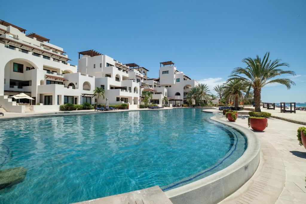 a large swimming pool in front of some apartments at Playa de La Paz by Lumina in La Paz