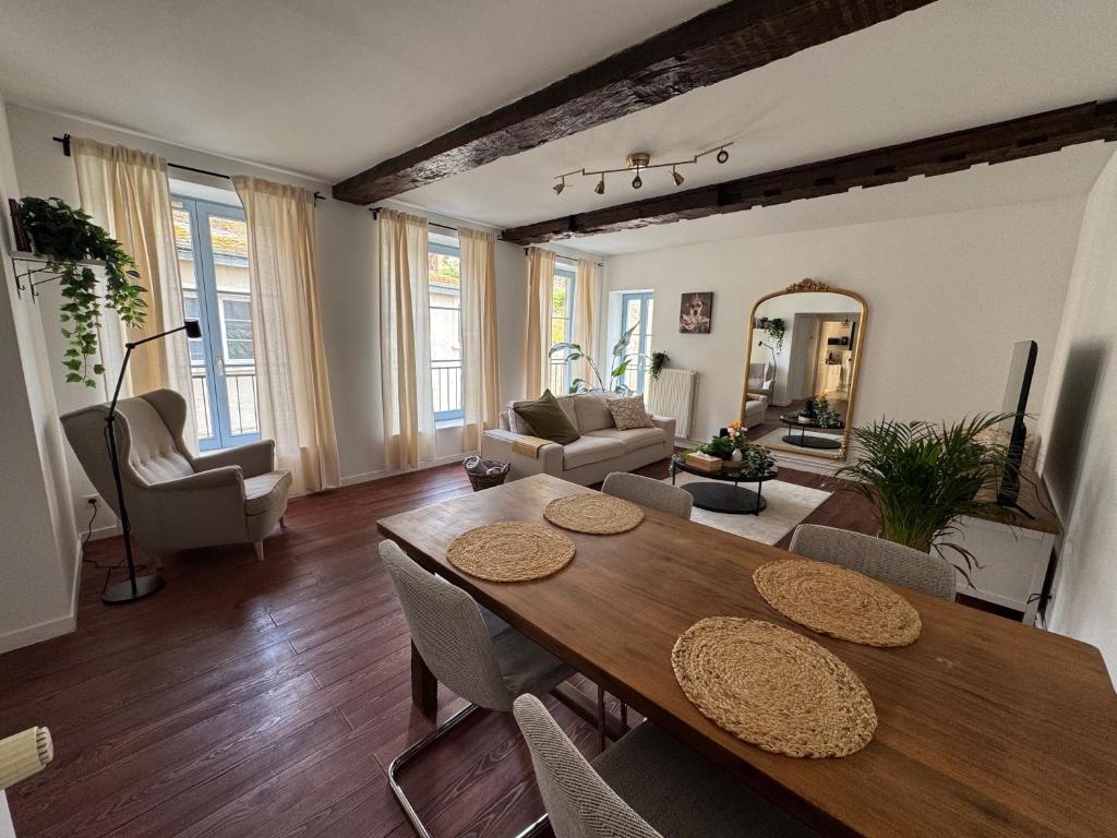 a living room with a wooden table and chairs at Appartement Sedan in Sedan