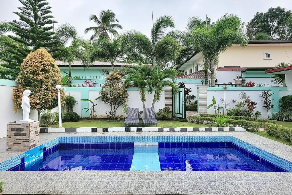 a swimming pool in the backyard of a house at Jewelry Resort and Villas Tagaytay in Silang