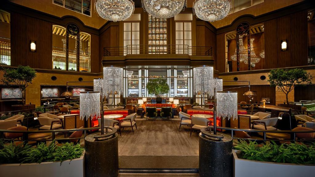 a hotel lobby with chairs and tables and chandeliers at Hyatt Regency Tokyo in Tokyo