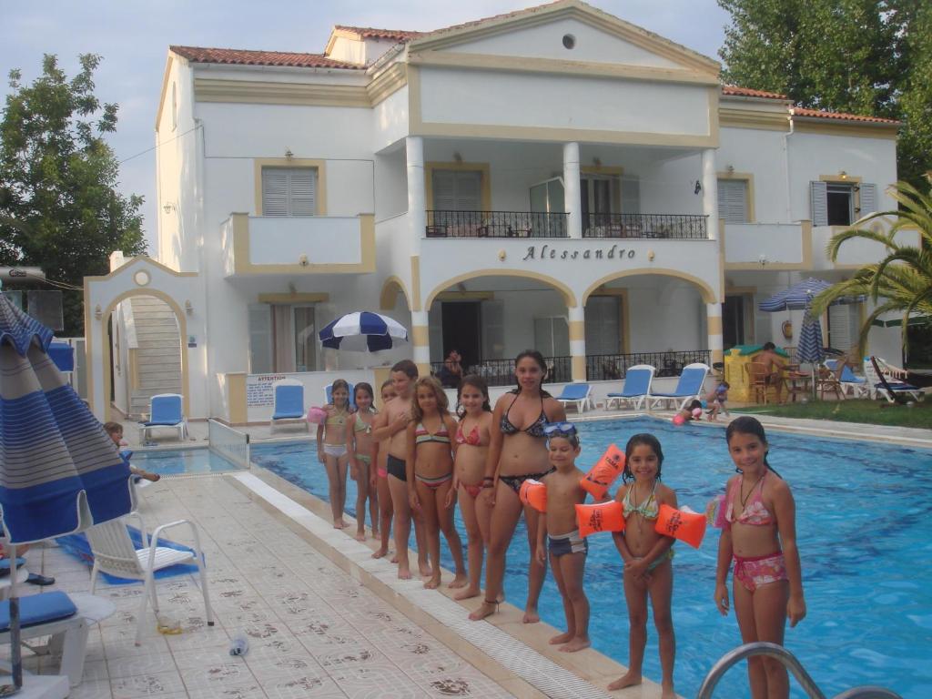 a group of children in bathing suits standing in a swimming pool at Alessandro in Sidari