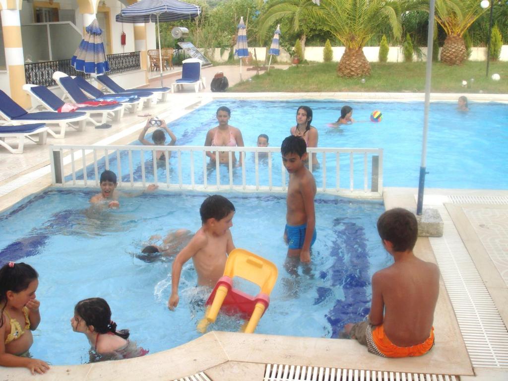 a group of children playing in a swimming pool at Alessandro in Sidari