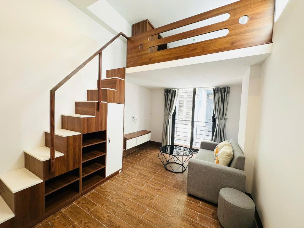 a living room with a staircase and a couch at 25House Cozy Apartment near West Lake & Airport in Hanoi