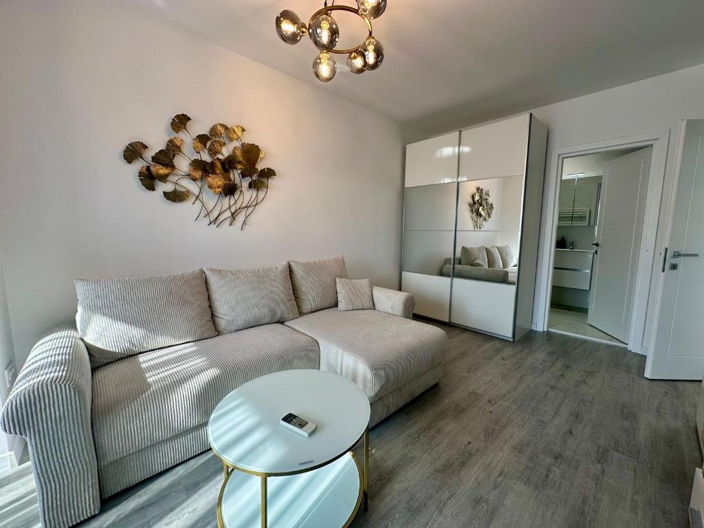 a living room with a couch and a table at Nucleo Pipera in Voluntari