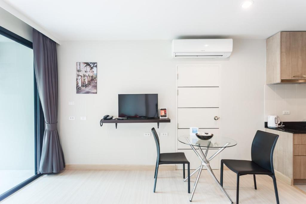 a living room with a table and two chairs at Apartments at The Bliss Condo by Lofty in Patong Beach