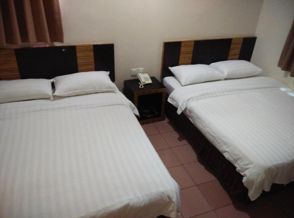 Postel nebo postele na pokoji v ubytování Hotel Traveller