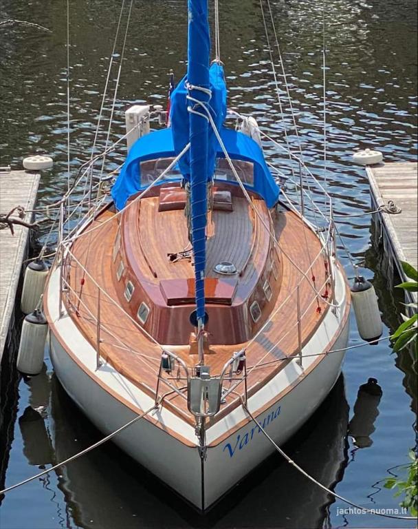 a boat is docked at a dock in the water at Varuna jachta in Nida