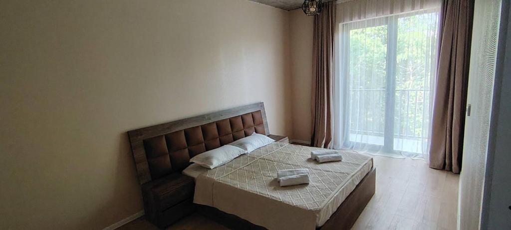 a bedroom with a bed with a table and a window at Villa Harmony Tianeti in Tʼianetʼi
