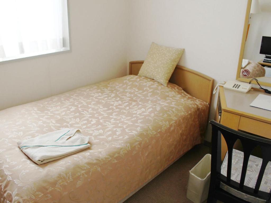 Postel nebo postele na pokoji v ubytování ロイヤルイン水戸-旧ホテルトレンド水戸-