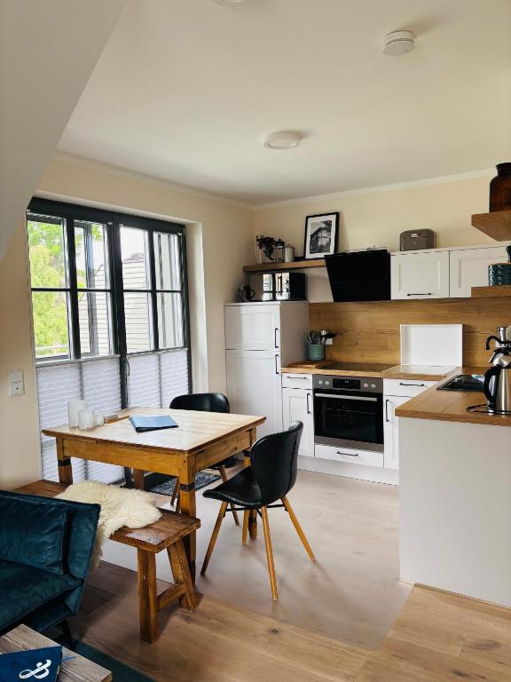 a kitchen with a table and chairs in a room at Zum Schwedenblick in Zingst