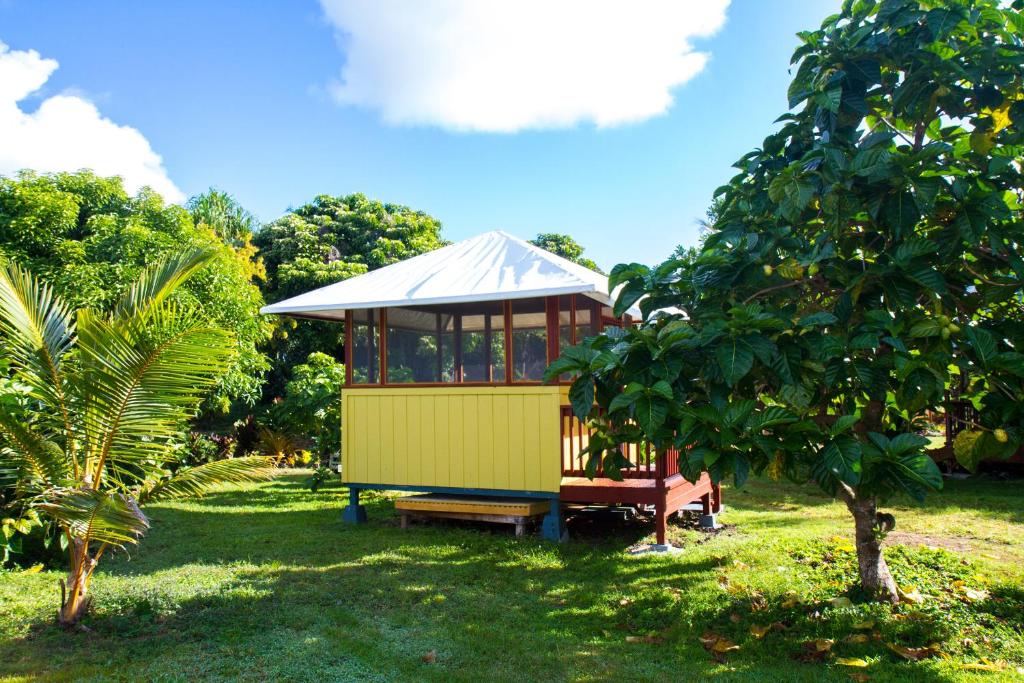 a small building in the middle of a field at Kirpal Meditation and Ecological Center in Pahoa