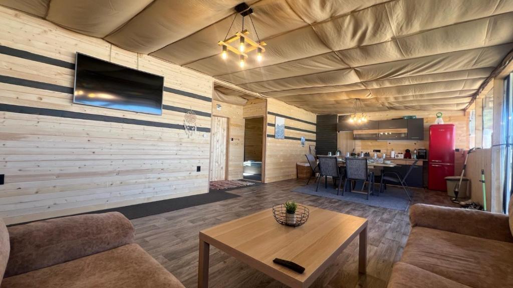 a living room with a couch and a table at Бунгало woodwave in Chernomorets