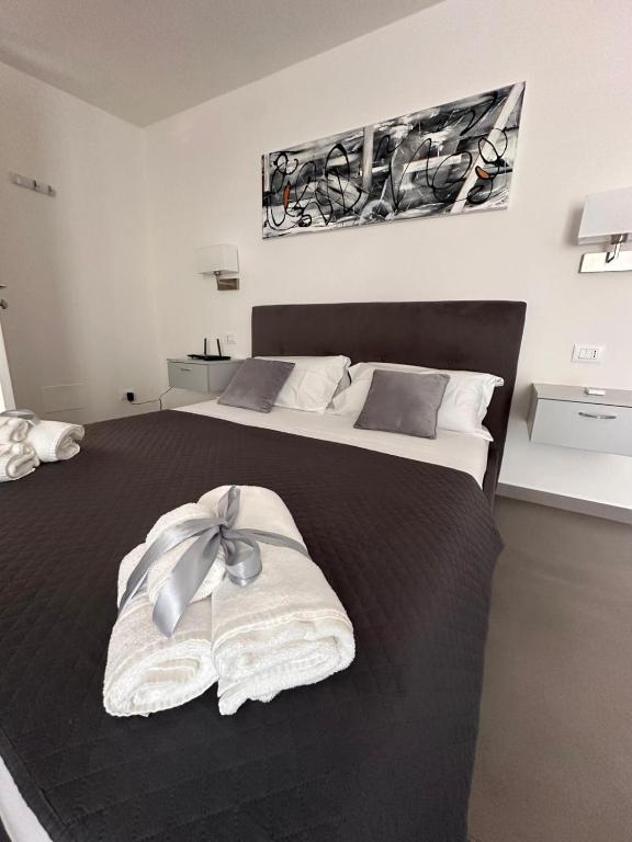a bedroom with two beds with towels on the bed at Royal View Apartment in Caserta