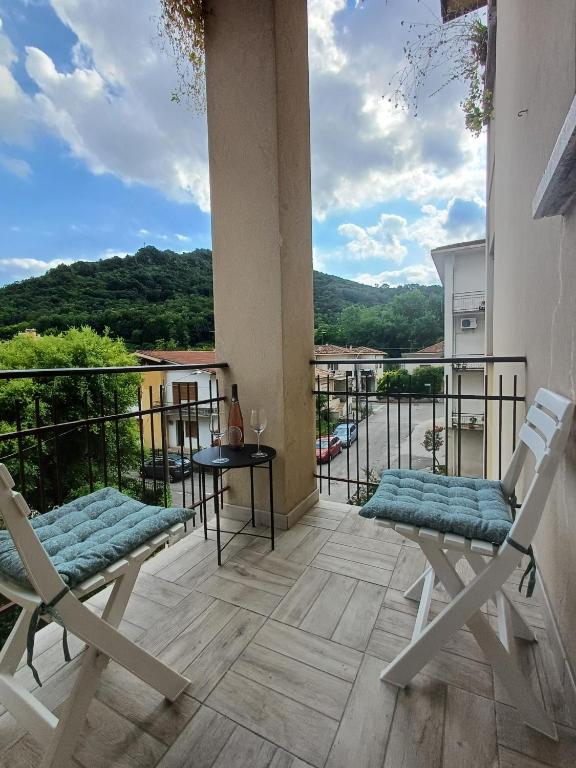a balcony with two chairs and a table with a view at Central Apartment Vittorio Veneto by Quokka 360 - a stone's throw from Piazza Flaminio in Vittorio Veneto