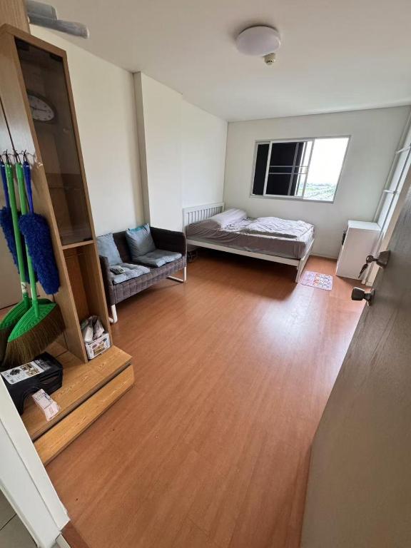 a living room with a couch and a table at Condo located 5 minutes away from Suvarnabhumi Airport by taxi for cooking, short-term rental, and long-term rental in Sathani Lat Krabang