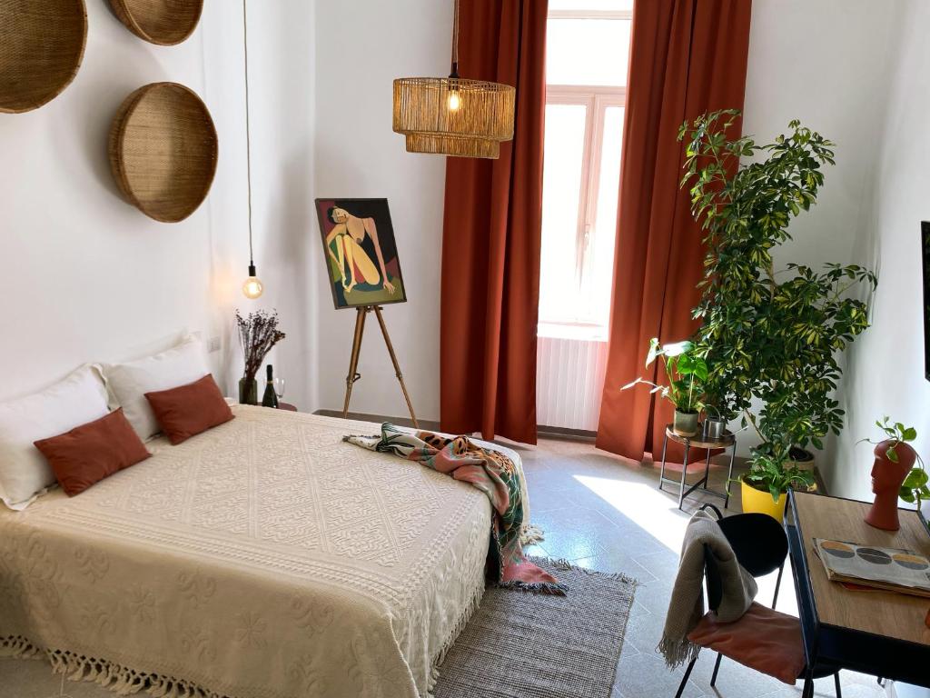 a bedroom with a bed with a woman laying on it at Elevada in Castellammare di Stabia