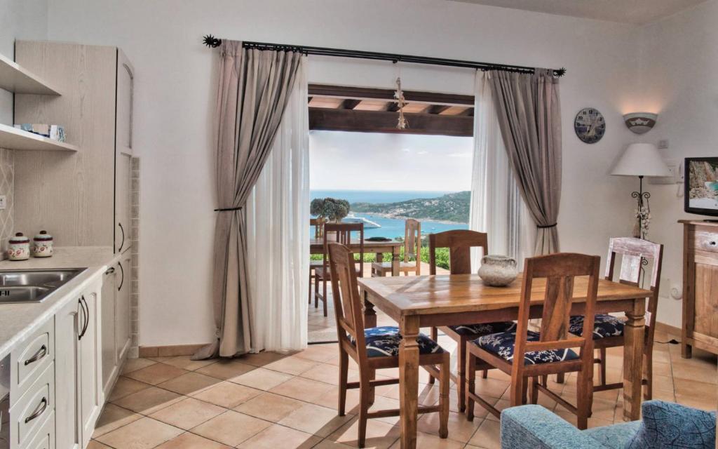 a kitchen and dining room with a table and chairs at Sea View Grande Pevero 8 in Porto Cervo