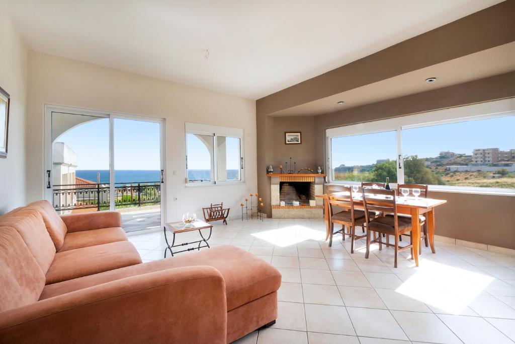a living room with a couch and a table at Nektar Luxury Apartment in Stalos