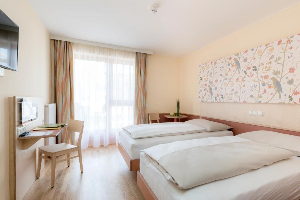 Postelja oz. postelje v sobi nastanitve JUFA Hotel Stubenbergsee