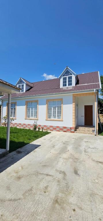 a white house with a red roof and a driveway at Aksn new small villa in Gabala