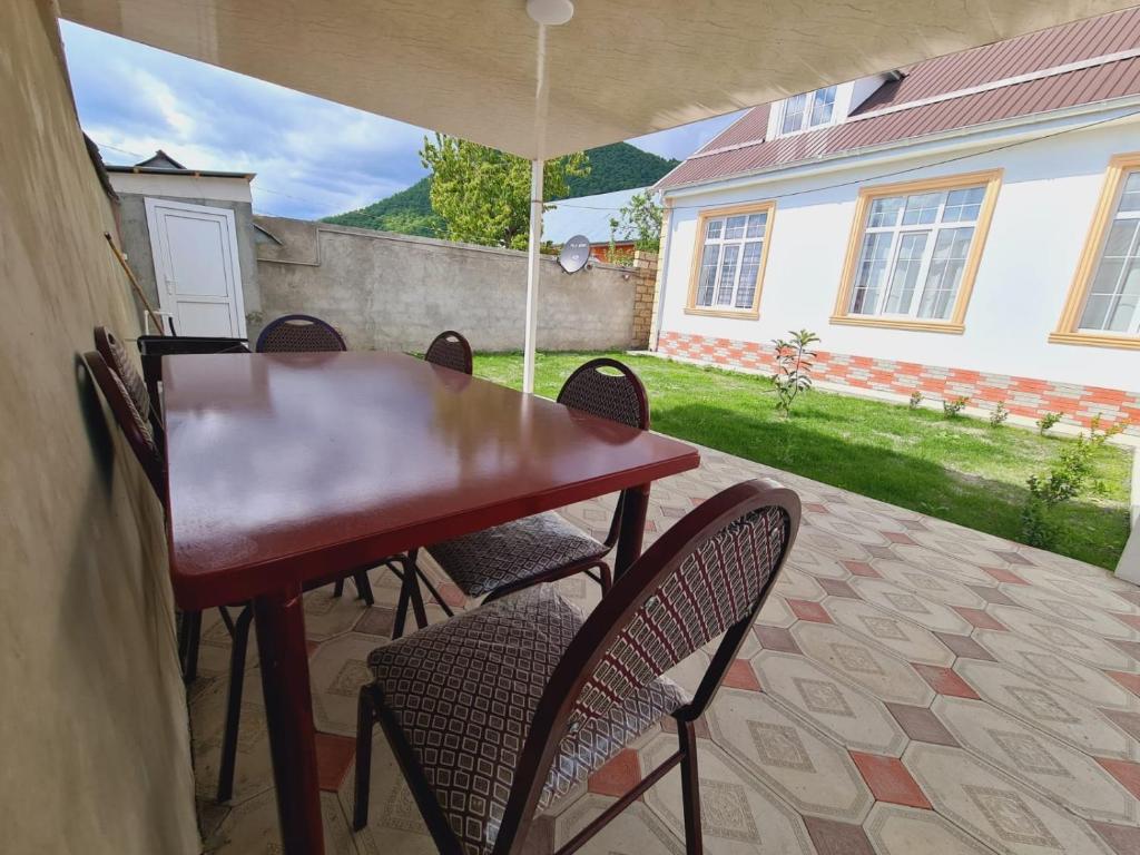 a table and chairs under an umbrella on a patio at Aksn new small villa in Gabala