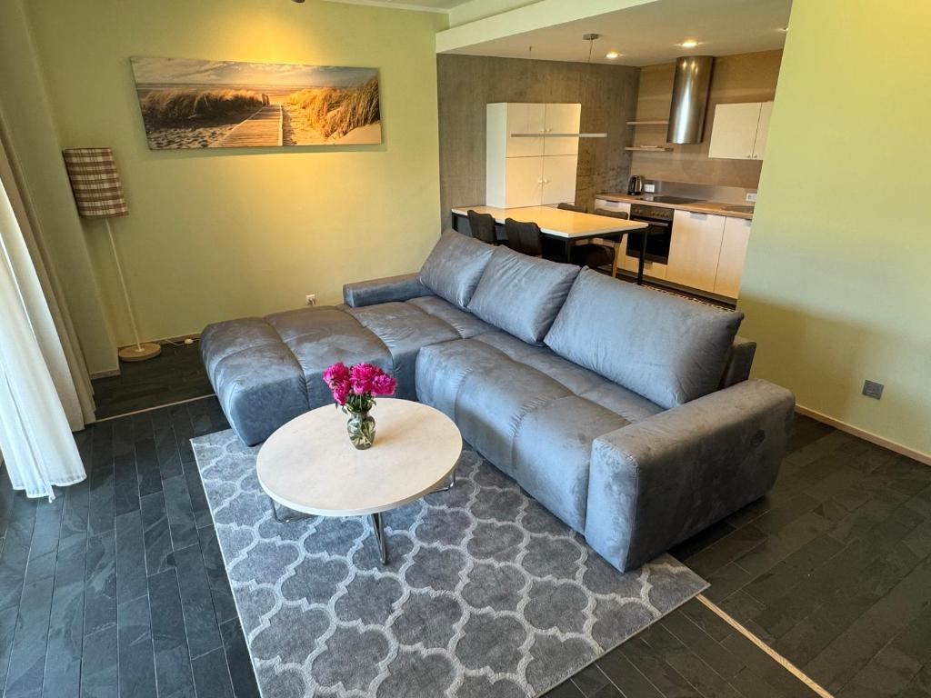 a living room with a couch and a table at Kuressaare Marina Apartment in Kuressaare
