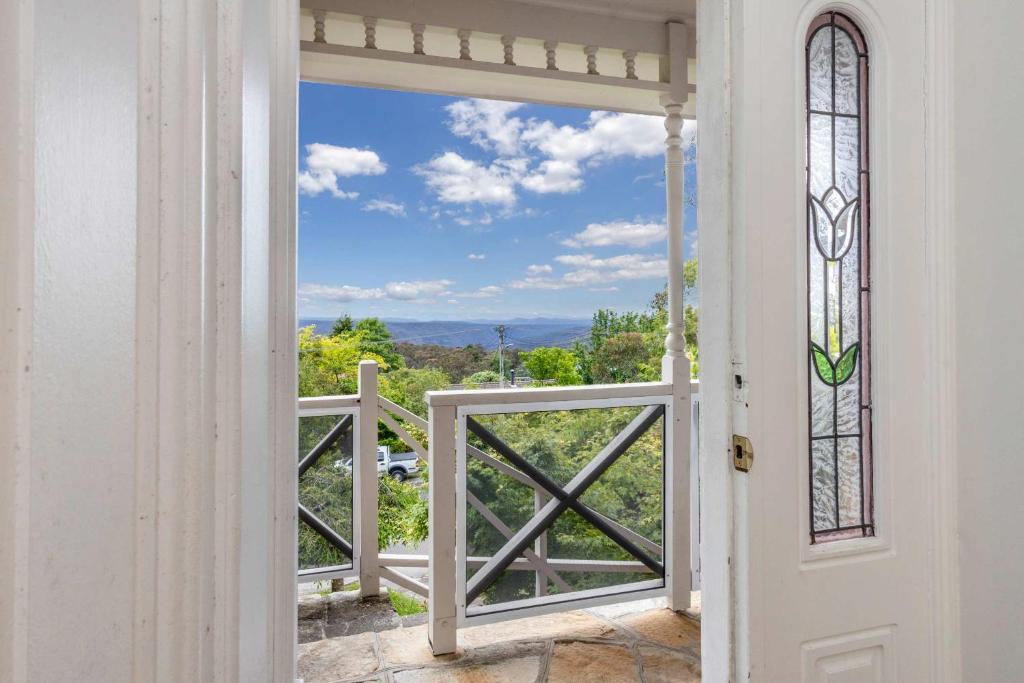 a door leading to a balcony with a view at Whisper on the Falls in Wentworth Falls