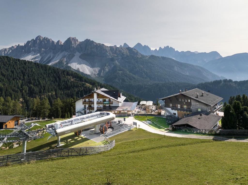an airplane is parked on a field in front of mountains at Berghotel Schlemmer Appartements in Plancios