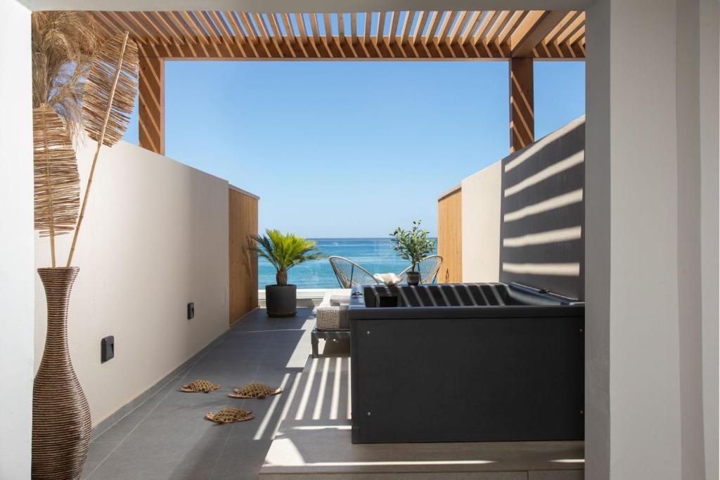 a living room with a view of the ocean at Ammos Suites in Rethymno