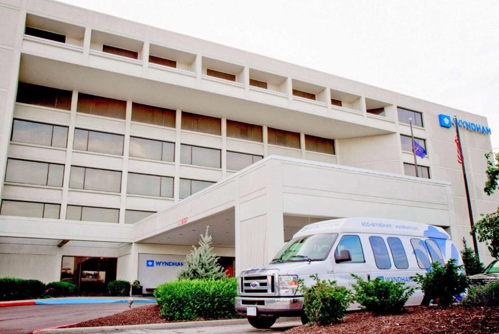 a white van parked in front of a hospital at Wyndham Indianapolis Airport in Indianapolis