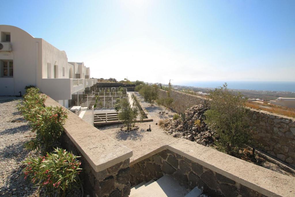 a view of a building with the ocean in the background at Airy Suites Santorini in Oia