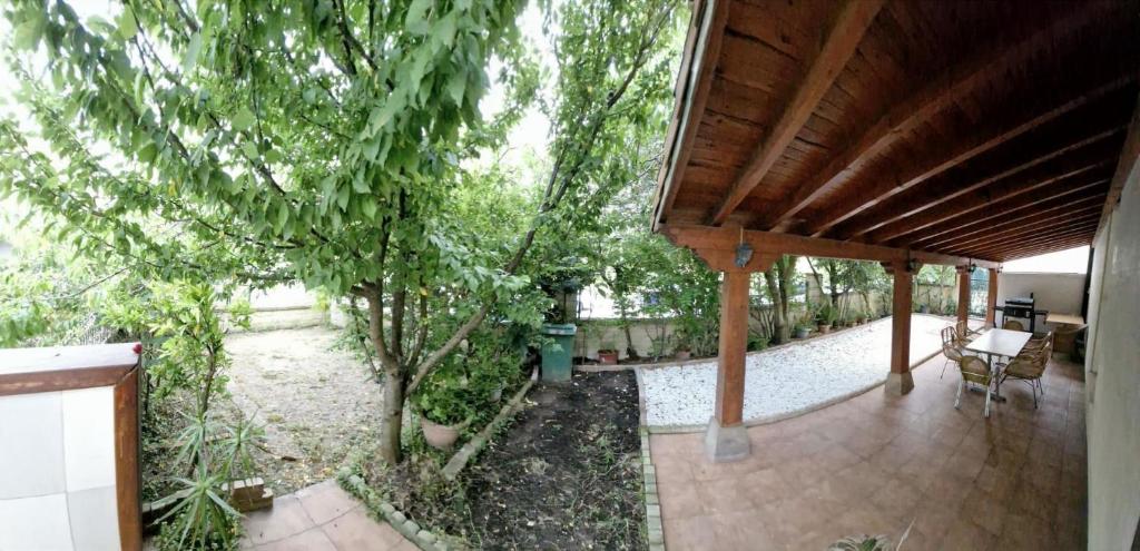 un portico con tetto in legno con un albero di Relax y conexion - cerca de todo a Santander