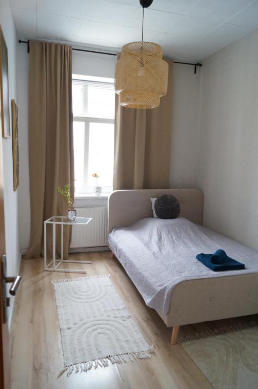 ein kleines Schlafzimmer mit einem Bett und einem Fenster in der Unterkunft Apartment Old Town in Bolesławiec