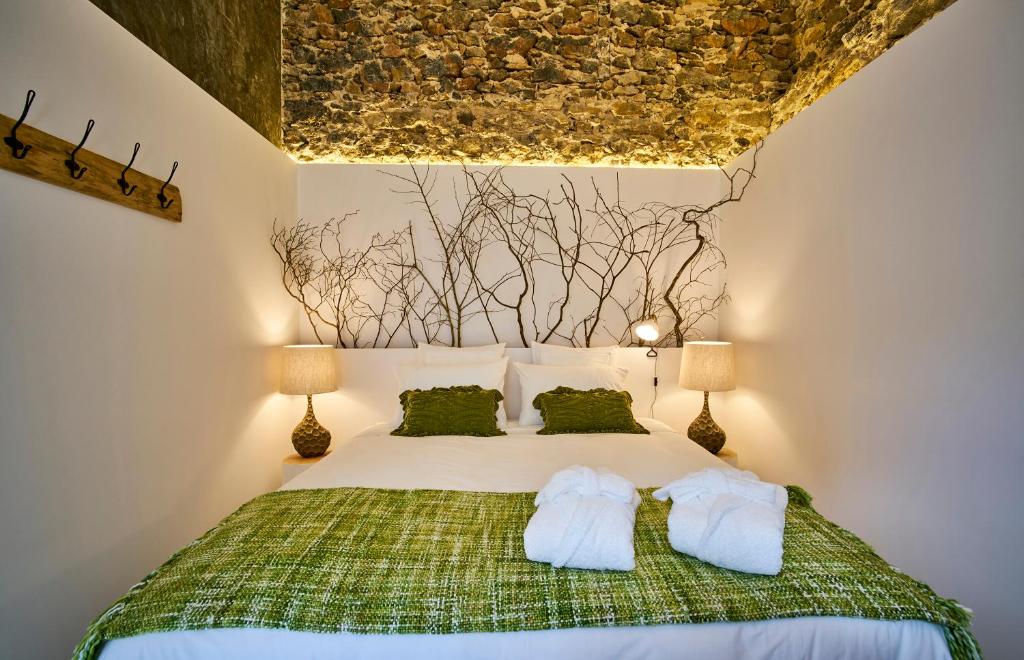 a bedroom with a bed with two pillows at Sparrow Sintra Nest in Sintra