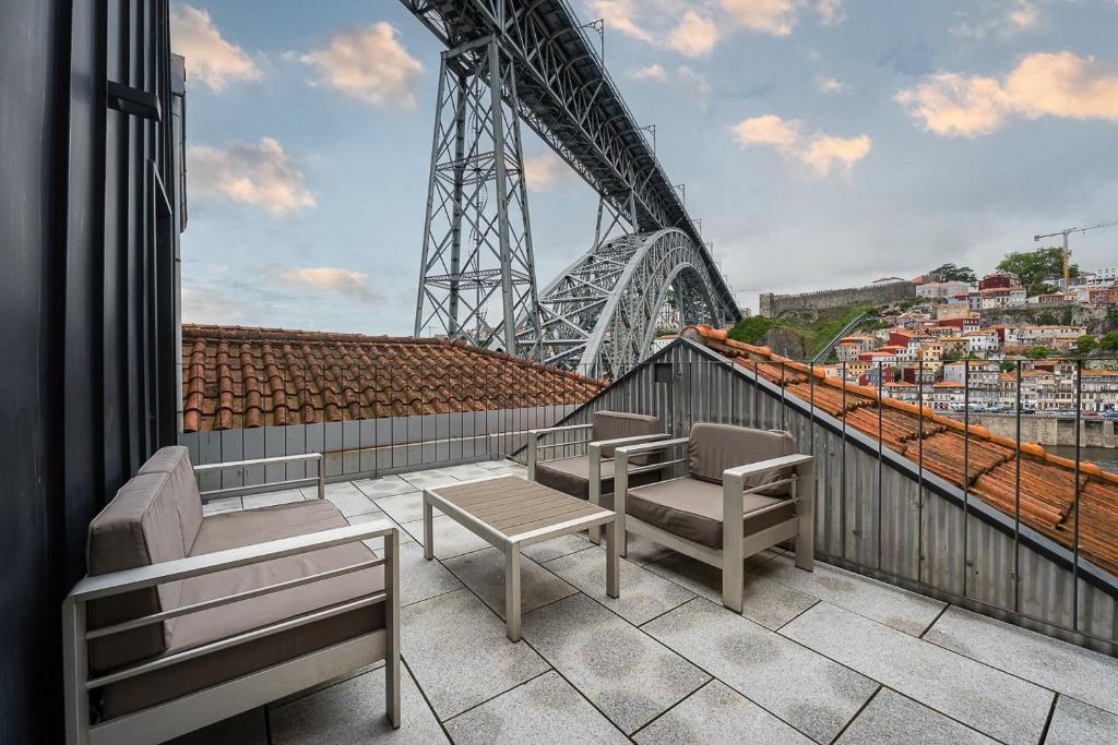 a balcony with benches and a view of the eiffel tower at GuestReady - Douro Nest Apartments in Bandeira