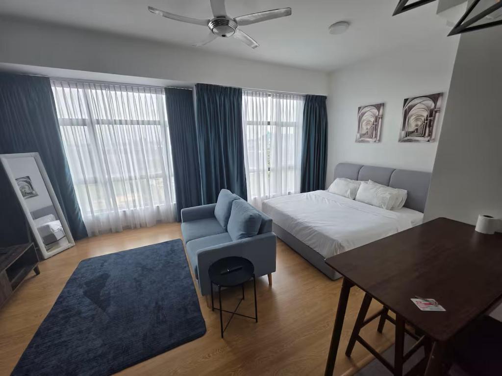 a bedroom with a bed and a table and a chair at Budget stay in Kajang town near to MRT in Kajang