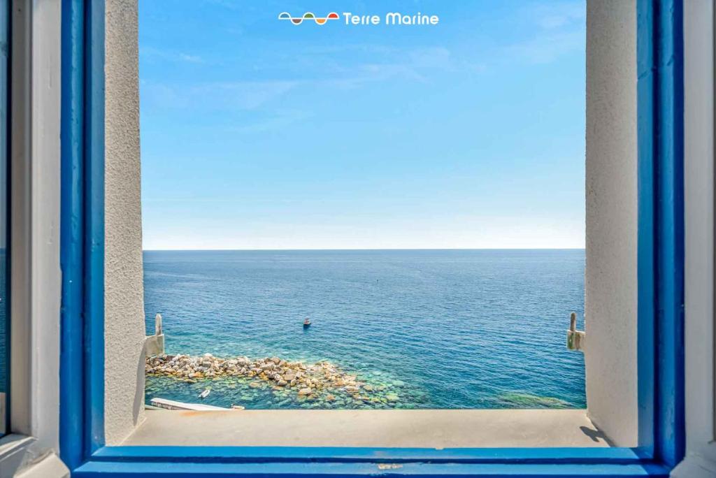 a view of the ocean through a window at Nidoo TerreMarine in Riomaggiore