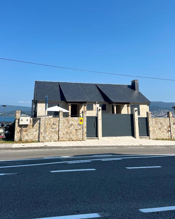 a house sitting on the side of a street at Chancelas b in Combarro