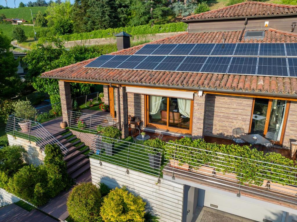 a house with solar panels on the roof at Villa DAutore in Alba