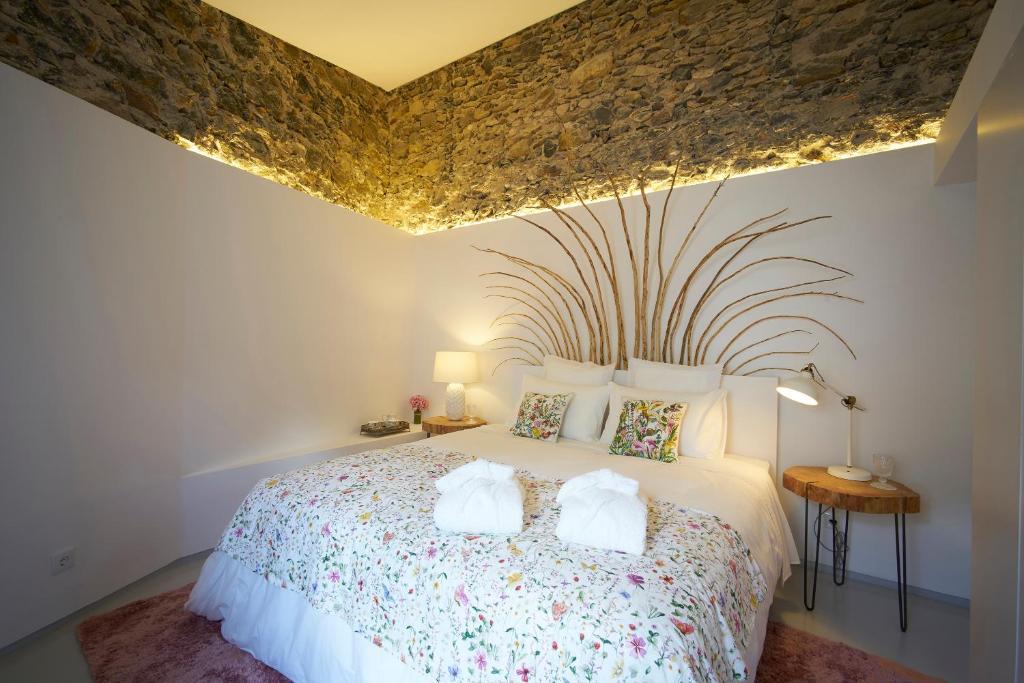 a bedroom with a bed with two towels on it at Sparrow Sintra Nest in Sintra